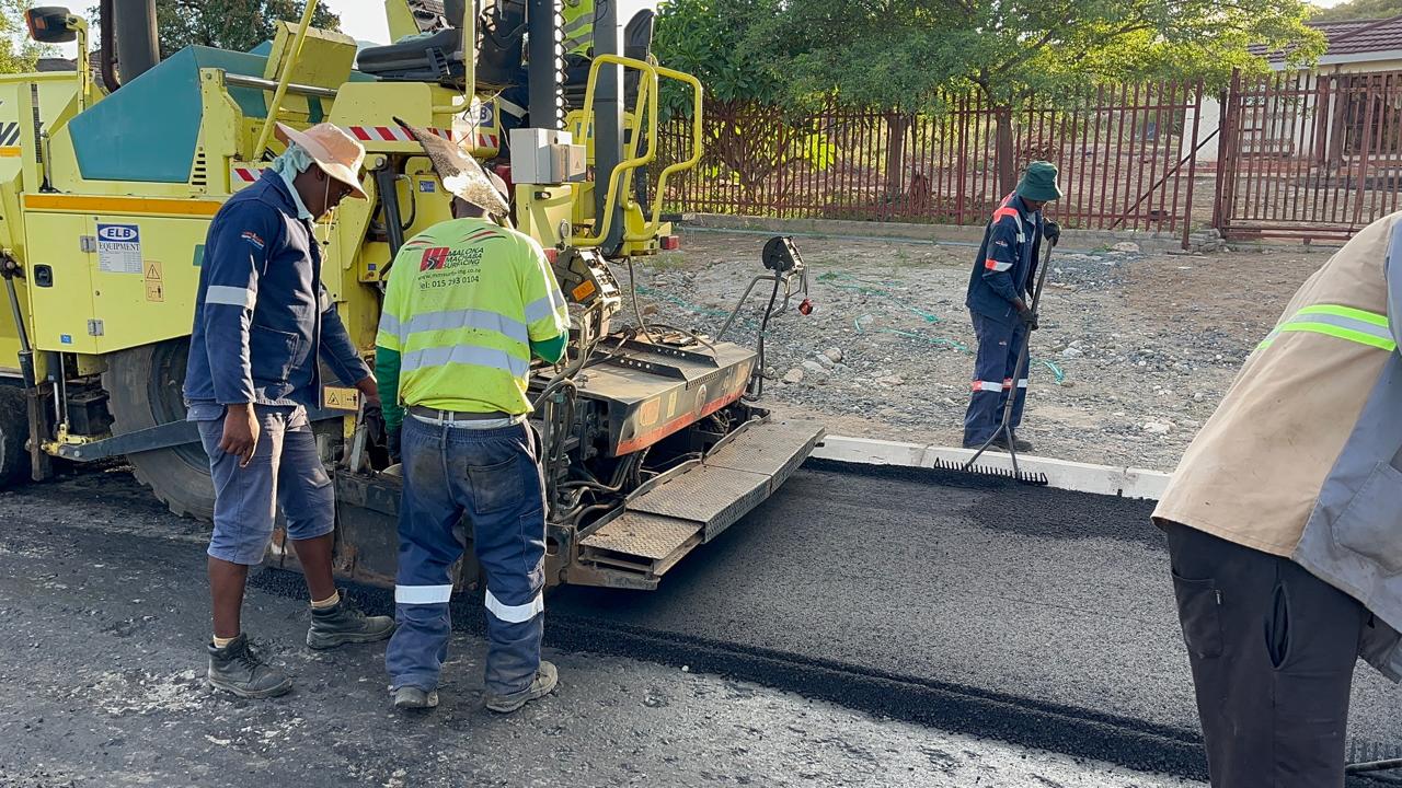 Asphalt laying process with professional equipment and safety protocols